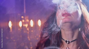 Young attractive woman smoking hookah in night club. Club party. Nightlife