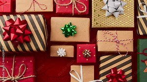 Stop motion animation with Christmas New year gift boxes appear on red cover