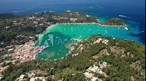Aerial drone video of iconic port and fishing village of Lakka with traditional Ionian architecture a safe anchorage for yachts and sail boats, Paxos island, Ionian, Greece