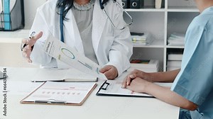Senior doctor meets with doctors in department to plan patient treatment and find treatment guidelines, hospital conference room, health examination planning meeting. Medical concepts and treatment.