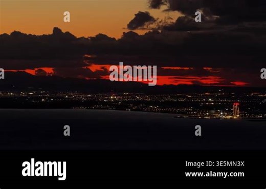 Aerial drone view of Ayia Napa coastline with city lights beginning to appear at dusk. Cyprus Stock Video Footage - Alamy