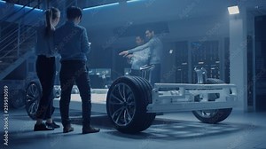 Team of Automotive Engineers Discussing and Designing Electric Car Platform Chassis Prototype, Taking Measures, Working with 3D CAD Software Checking Quality Control. Vehicle Frame with Wheels, Engine