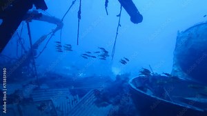 Underwater shipwreck and debris, video from scuba diving. Wreckage, deep blue sea and swimming fish. Remains of the ship, travel scuba diving adventure. Exploring the ship wreck. Stock Video