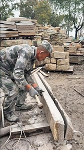 Splitting a large stone slab by hammering along the cut line for a straight break