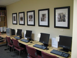 Row of computers, row of photographs.