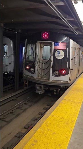 MTA E-Train departs Spring Street subway station