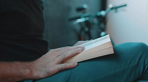 Stock Video Hipster Reading A Book Next To A Bicycle Animated Wallpaper