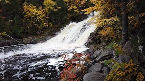 Mary Ann Waterfalls, Cape Breton, Nova Scotia. A vibrant high waterfall river in autumn season. Gushing water fall in an autumn forest landscape. Autumn waterfall view in Cape Breton.