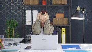 Close-up of young woman shrinking and depressed.Depressed young woman at home panics, can't breathe, constricts.