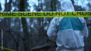 Field forensic expert working with evidence on site, yellow crime scene tape. Crime scene investigation in progress