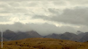 The time-lapse video capture of movement of clouds on mountains.