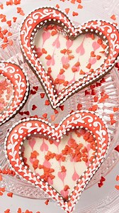 I used boiled sugar to create a transparent window on these sprinkle filled cookies 💗 #icingcookies #valentinesdaycookies #decoratedcookies #royalicingcookies | SweetAmbs