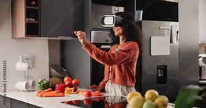 Girl, cooking and vegetables with VR in kitchen for healthy meal, nutrition or vitamins at home. Happy female person preparing food with smile in virtual reality, simulation or interaction at house