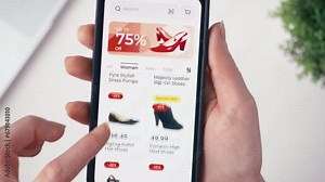 Christmas online shopping using smartphone retail app. Holiday sale with great discounts and special offers. Scrolling through a catalog of shoes. Fictional interface.