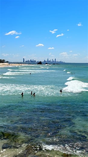 There's nothing like the Gold Coast in summer - where the only thing warmer than the water is the welcome from the locals 🥰 Base your stay poolside at QT Gold Coast and make the most of the long balmy days, soaking up the sunshine along the city's famous beaches and dining by the water at The Tropic and Rick Shores🍹 📍: Experience Gold Coast, Visit Queensland, Australia #SeeAustralia #ComeAndSayGday #QueenslandHolidayFeeling ID: A series of videos shows people enjoying a coastal city with gold