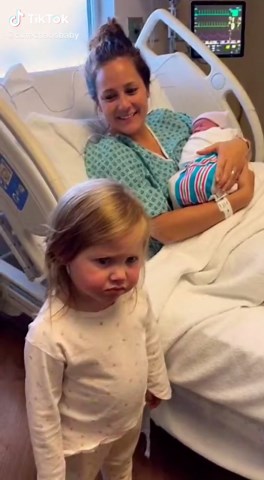 explosive in seconds A stunning toddler girl runs toward Mom, proudly holding flowers and smiling with excitement… Then she sees the baby. Freeze. Shock. Instant toddler rage. Flowers hit the floor Arms crossed like a tiny diva One tiny baby sound = TOTAL outrage Dressed like a Paris 1980 winter runway model, her reaction is pure comedy — no words needed. Filmed like a real parent holding the phone too close 🇫🇷 Luxury French fashion × raw toddler jealousy logic Feels accidental, real, and impo