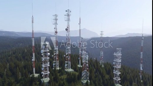 Antennas complex on a forested hill. Radio masts and towers for broadcasting.