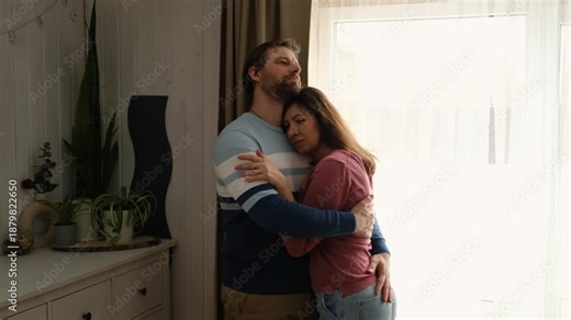 Loving mature couple interactions at home. Man and woman embracing, hugging, holding hands and dancing. Wife with husband intimate moments. couple is touching, cuddling, kissing. Natural lighting. 4K