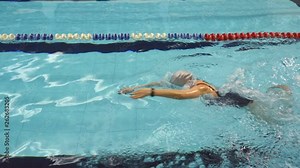 Woman studying butterfly in swimming pool, Full HD steadicam shot