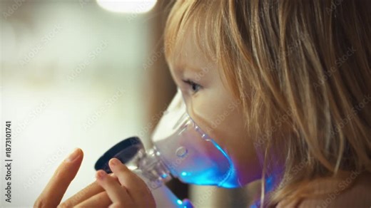 A young girl's breathing is eased by a nebulizer, which delivers a medicated mist into her bronchi, reducing the discomfort of bronchitis. Inhalation therapy helps relieve congestion caused by a cold