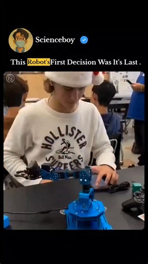 Deepak Kumar on Instagram: "This video is a classic example of "robotic humor," capturing a moment where a machine's programming (or lack thereof) creates a perfectly timed comedic beat. The Scene In the clip, a student is sitting at a desk with a small, blue robotic arm. The robot is equipped with a camera and a gripper, designed to interact with objects on the table—in this case, two small blocks (one red, one blue). What Happens The Setup: The robot is powered on and begins its "first decisio