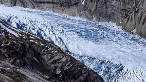 A Gorgeous Timelapse of a Powerful Glacier Flowing Downhill Like a River Through a Frozen Valley