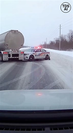 Semi Truck Slides Into Police Cruiser on Icy Highway During Winter Conditions Dash camera footage captures a tense moment on an icy stretch of highway in Fargo, North Dakota, as a semi truck loses traction and slides into a marked police cruiser during hazardous winter conditions. The cruiser was positioned on the roadway as part of a traffic response when the truck began drifting sideways on the slick pavement. The video shows the semi unable to regain control as freezing temperatures and ice-c