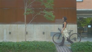 Girl walking with a bicycle on the sidewalk - Free Stock Video