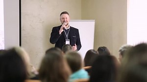 clip-26040764-speaker-on-podium-people-conference-hall-rear