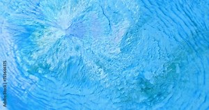 Close up, bright blue paint splash abstract background. Turquoise color water with ripples surface texture. Depth blue ink movement pattern. White water wave spread in motion aquamarine liquid art