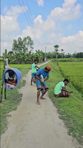 The man is sitting by the side of the road.
