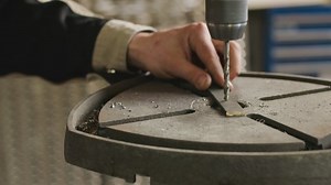 Close up of drilling machine working at factory under control of unrecognizable male worker