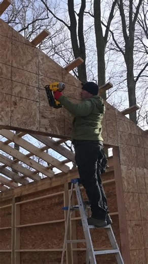 Installing OSB on the DIY pole barn. Same process every sheet—measure, manage the load, cut just shy, and keep moving. Gaps don’t matter, siding covers it. #HomeProHero #polebarn #OSBinstall #DIYbuild