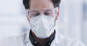 Man, scientist and vial in chemical experiment at the lab for research, discovery or testing compound at workplace. Male professional wearing safety mask and glasses with science tubes in laboratory