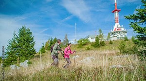 Adventurous couple trekking uphill at Mount St. Ursula in slow motion