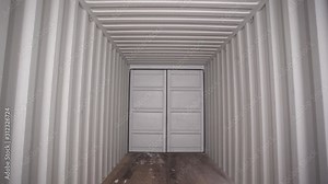 Inside large shipping container. Stock footage. View from inside locked cargo container with white striped iron walls. Empty light and locked cargo trailer container Stock Video