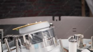 Videocassette recorder head and details in light studio macro view. Working mechanism of open recorder. Vintage tape recorder repairing process