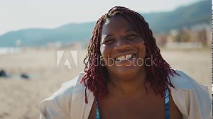 Cinematic storytelling footage of beautiful plus size women having fun at the beach in the summertime. Oversized big girls friends, representation of body positivity and body acceptance concepts