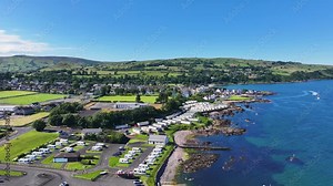 Aerial View of Cushendall Caravan Park and Lurig Caravan Club on the Irish Sea Cushendall Co Antrim Northern Ireland on a sunny day 27-07-24