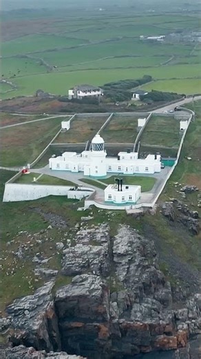 Aerial orbit of Pendeen Lighthouse on Cornwall’s dramatic north coast.