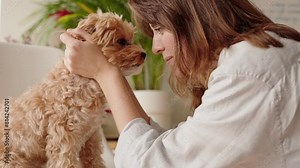 Intimate moment between a woman and her dog as they touch foreheads, showcasing the special bond and affection shared.