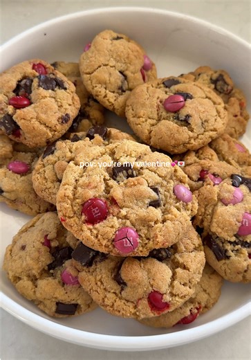 Valentine’s chocolate chip m&m cookies 🍪💕 Ingredients: 1/2 cup of butter, softened (1 stick) 1 cup brown sugar 1 egg 2 tsp vanilla 1 tsp baking powder 1/2 tsp baking soda 11/2 cup flour Instructions: 1. In a large bowl mix together butter & brown sugar. 2. Add in egg, vanilla, baking powder, baking soda, & flour. Mix until combined. 3. Add in chocolate chips & v-day m&m's. 4. Form cookie dough into balls and lay them on a parchment lined baking sheet. 5. Bake at 350° for 10 minutes. 6. Enjoy! 