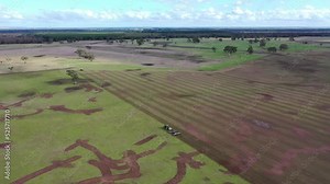 Tractor sowing a crop in a paddock and field