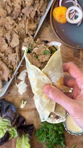 Bobby Parrish on Instagram: "Viral Doner Kebab🌯 Recipe below👇 Ingredients: 28 ounces ground beef 1 medium onion, grated 2 tablespoons Primal Kitchen Ranch Dressing 2 tablespoons greek yogurt 1 teaspoon garlic powder 1 teaspoon of cumin 1 teaspoon of paprika ¾ teaspoon salt Few cracks of pepper Wrap: Tortillas Onions Tomatoes Primal Kitchen Ranch Dressing Parsley Directions: Preheat your oven to 400°F. Grate the onion using a hand grater on the small side, or pulse it in a food processor til it