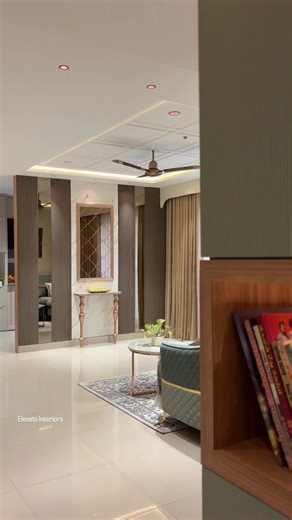 A living area where details do all the talking ✨ The statement wall steals the spotlight with elegant patterned glass panelling, perfectly paired with warm vertical louvre panels for depth and rhythm. Anchoring the space is a sleek console table with refined duco finish, adding a touch of understated luxury. Soft lighting, balanced textures, and thoughtful craftsmanship come together to create a space that feels both inviting and elevated. 📍Hyderabad 📍Elevate Interiors 📲 91-9392983335 Interio