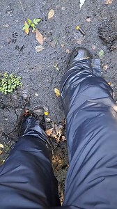 boy walking through mud bog sinks deep in mud