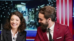 Midnight show hosts covers latest news, going live on international television program and presenting daily events. Media reporters hosting entertainment segment on late night talk show.