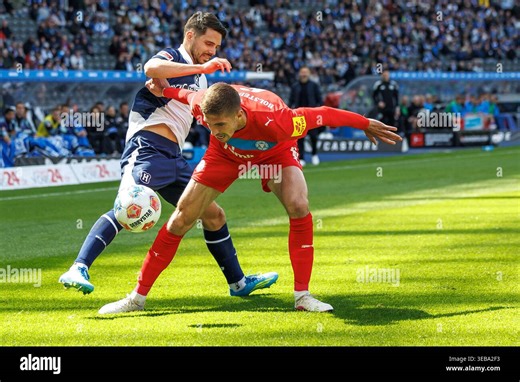 25 April 2026, Berlin: Soccer, Men: Bundesliga 2, Hertha BSC - Holstein Kiel, Matchday 31, Olympiastadion. Marko Ivezic (r, Holstein Kiel) fights for the ball against Josip Brekalo (l, Hertha BSC). Photo: Andreas Gora/dpa - IMPORTANT NOTE: In accordance with the regulations of the DFL German Football League and the DFB German Football Association, it is prohibited to utilize or have utilized photographs taken in the stadium and/or of the match in the form of sequential images and/or video-like p