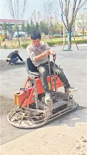 Mastering Infrastructure: Operating a Ride-On Power Trowel for Smooth Paving