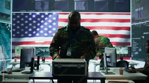 US military personnel work in a modern army command post, safeguarding classified information and state secrets against cyber attacks. Digital warfare and cybersecurity operations. Camera B.